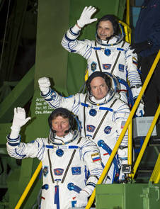 Year in Space Starts for One American and One Russian 4 Expedition 43 crew members Mikhail Kornienko of the Russian Federal Space Agency (Roscosmos), top, NASA astronaut Scott Kelly, center, and Gennady Padalka of Roscosmos wave farewell as they board the Soyuz TMA-16M spacecraft ahead of their launch to the International Space Station. Image Credit: NASA/Bill Ingalls