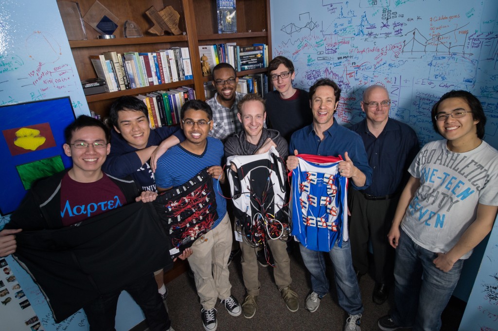 Showing prototypes at neuroscientist David Eagleman's Baylor office are, from left, students John Yan, Eric Kang, Abhipray Sahoo and Edward Luckett, graduate student Scott Novich, student Evan Dougal, advisers Eagleman and Gary Woods, and student Zihe Huang. (Credit: Jeff Fitlow/Rice University)