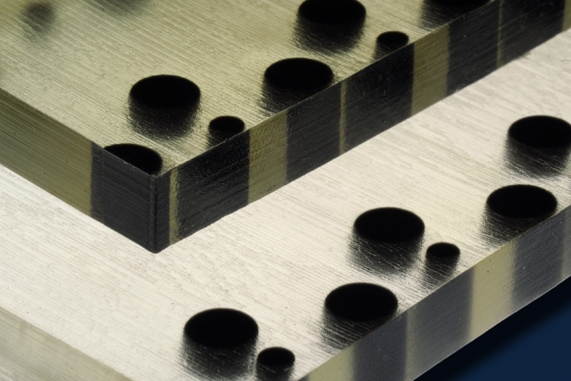 Surfaces get smooth or bumpy on demand 2 Polymer material produced by a 3-D printer includes soft, flexible material (clear or lighter tone) with particles of hard material (black) embedded, in predetermined arrangements. When the material is compressed, its surface become bumpy in a pattern determined by the hard particles. Photo: Felice Frankel