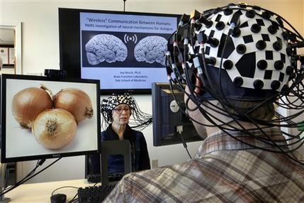 Lasers, Magnetism Allow Glimpses of the Human Brain at Work 2 Shaw Bronner, left, and Shaul Yahil, two researchers at the Yale Brain Function Lab, describe images on their computer screens to each other while their brain activity is mapped during a demonstration of the technology in New Haven, Conn. (Richard Drew/Associated Press)