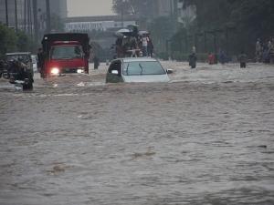 A car tries to drive through Jakarta's flooded streets, Indonesia, January 17, 2013.