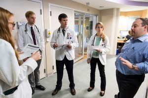 Josh Medow, right, medical director of the Neurocritical Intensive Care Unit at UW Hospital and Clinics, discusses a patient’s progress with medical students during the group’s floor rounds. CREDIT: Jeff Miller/UW-Madison 