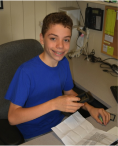 Student Ryan Beam holds his Clip Catch, a winning design in the Future Engineers 3-D Space Container Challenge. Credits: Ryan Beam