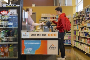 A student shopper uses the new Fetch Rewards lane at Fresh Madison Market. Customers press “checkout” on their phone and it sends the information to the cashier, who has a Fetch Rewards tablet.  Photo: Lauren Richards  