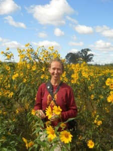 Amy Alstad stands in a bunch of Sawtooth Sunflowers that she describes as glorious. PHOTO: JESSE MILLER 