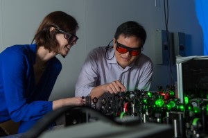 Rice University chemist Christy Landes, left, works with postdoctoral researcher Hao Shen to adjust lasers for the lab's super temporal resolution microscope. The lab invented a technique to acquire better data about molecules that move faster than a standard lab camera can capture. (Credit: Jeff Fitlow/Rice University) 