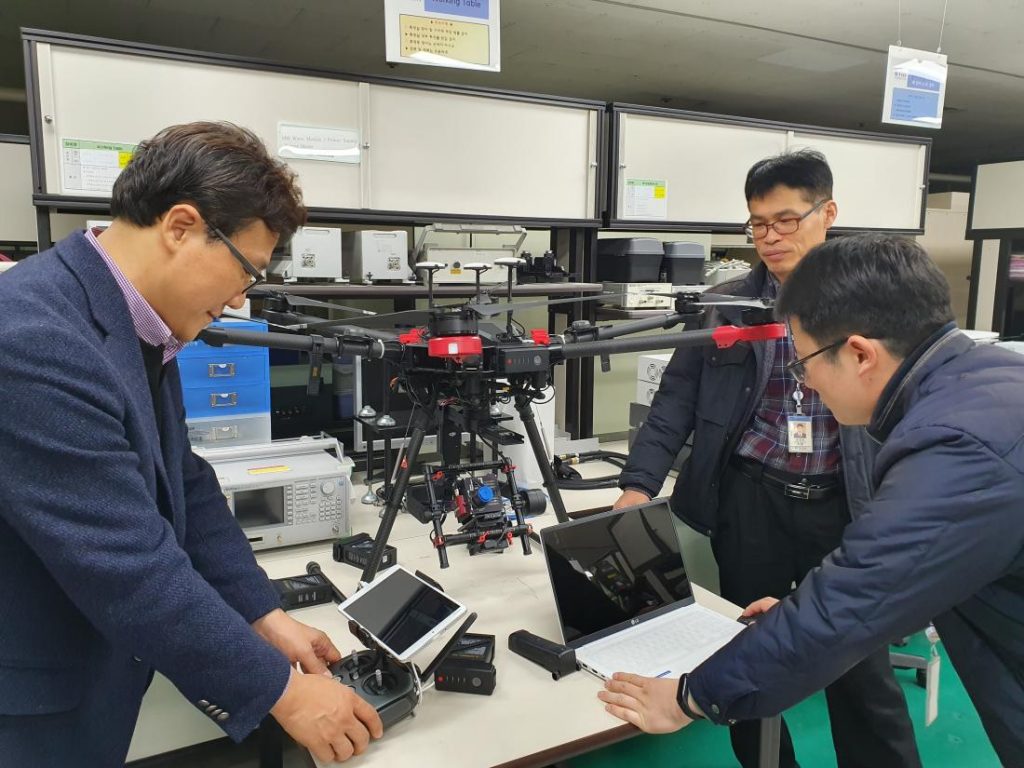 caption ETRI researchers inspecting hyperspectral camera drone