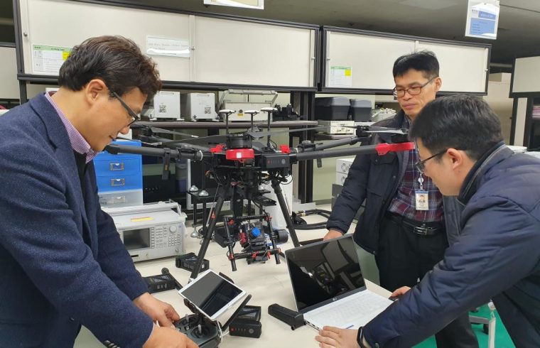 caption ETRI researchers inspecting hyperspectral camera drone